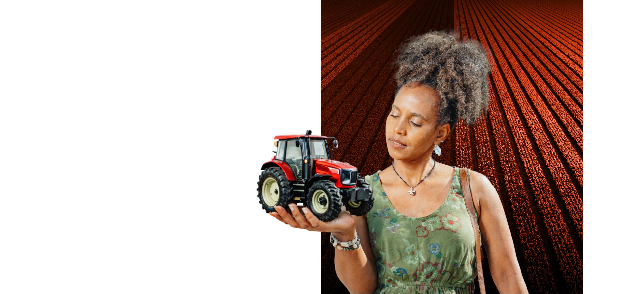 Woman holding a model tractor in front of a furrowed-field deep-rust block